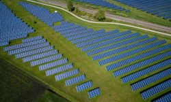 aerial photography of grass field with blue solar panels